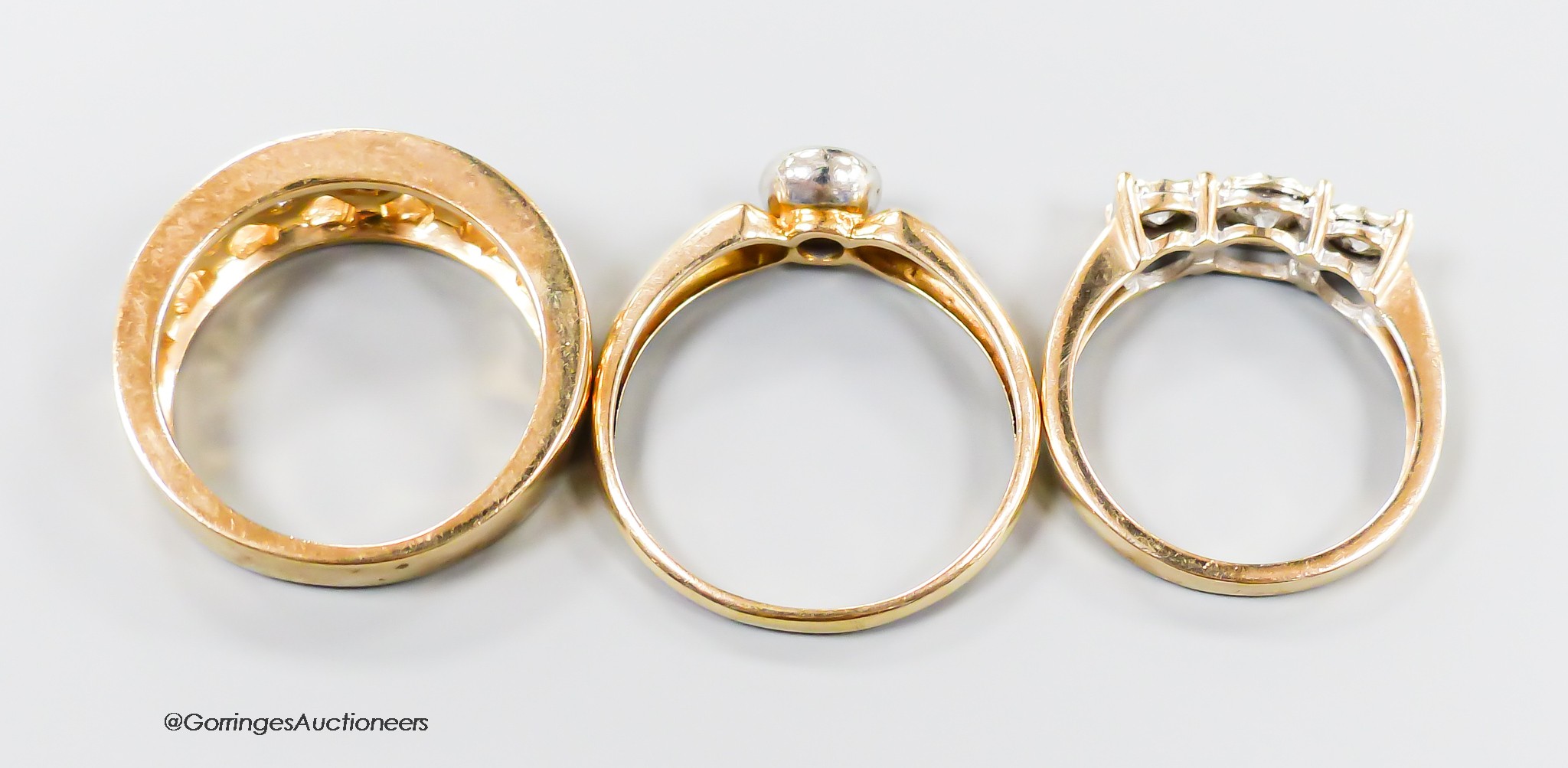 Three assorted modern 9ct gold and diamond set dress rings, including illusion set three stone and solitaire, gross weight 9.5 grams.